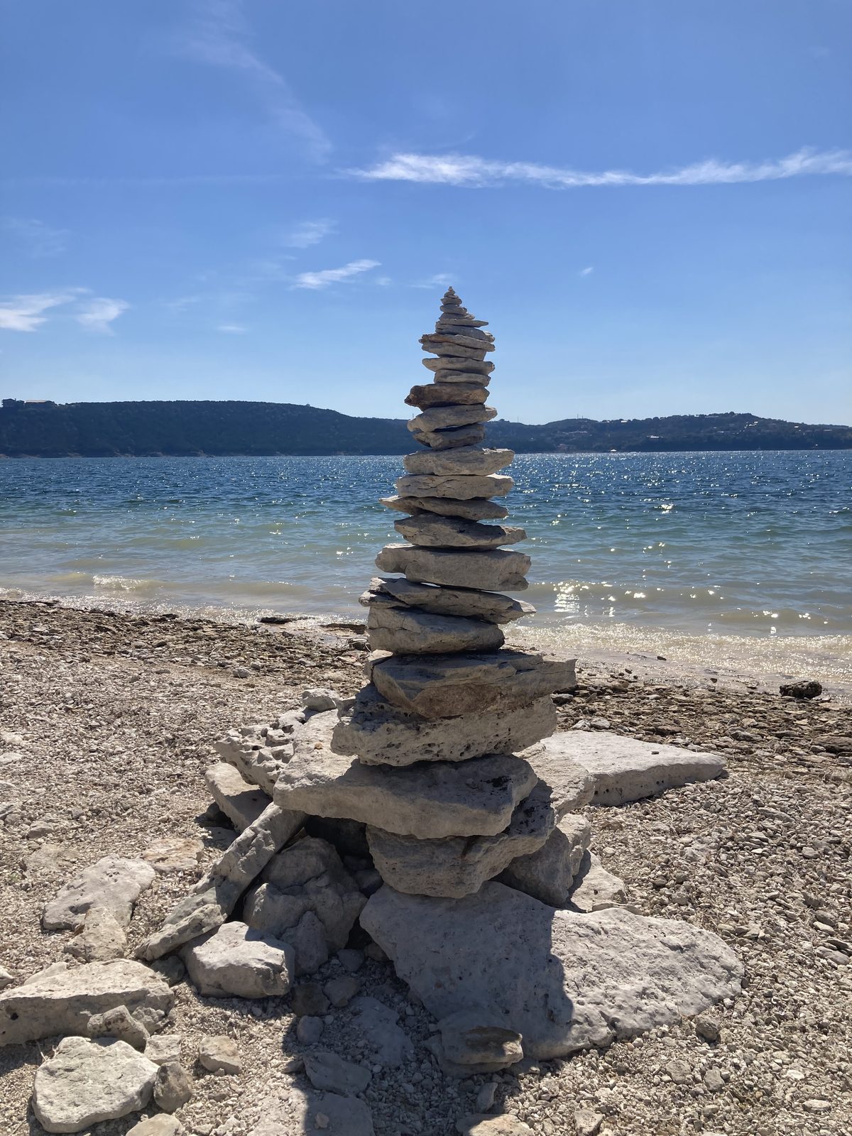 Stacked rock cairn at the shoreline